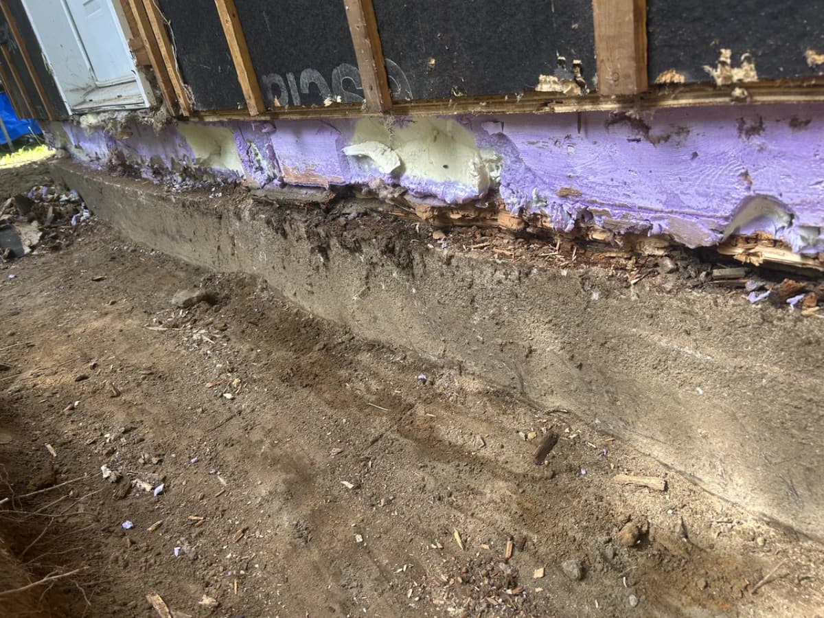 Base of the wall and rim joist exposed before repair